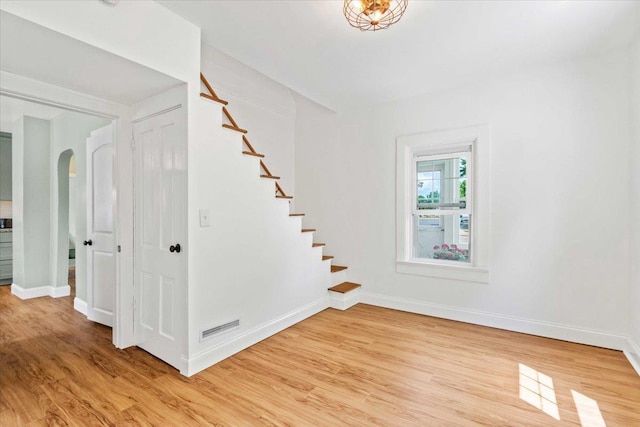 117 6th St, Nekoosa, WI 54457 - stairway featuring wood finished floors and arched walkways