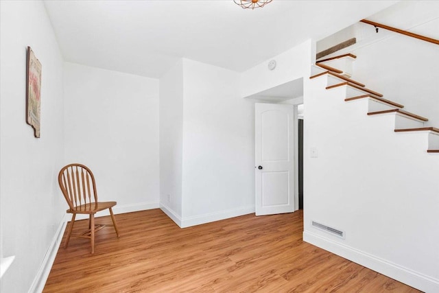 117 6th St, Nekoosa, WI 54457 - unfurnished room with light wood finished floors, stairway, and a smoke detector