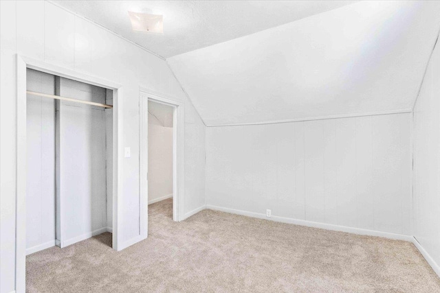 117 6th St, Nekoosa, WI 54457 - unfurnished bedroom featuring carpet flooring, vaulted ceiling, and a closet