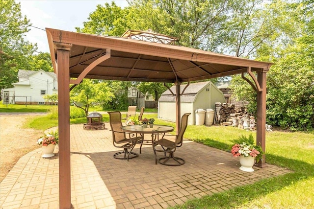 117 6th St, Nekoosa, WI 54457 - view of patio / terrace featuring a storage unit, a gazebo, outdoor dining area, and an outdoor fire pit