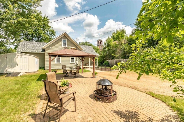 117 6th St, Nekoosa, WI 54457 - view of patio / terrace with an outdoor fire pit, a gazebo, and a storage shed