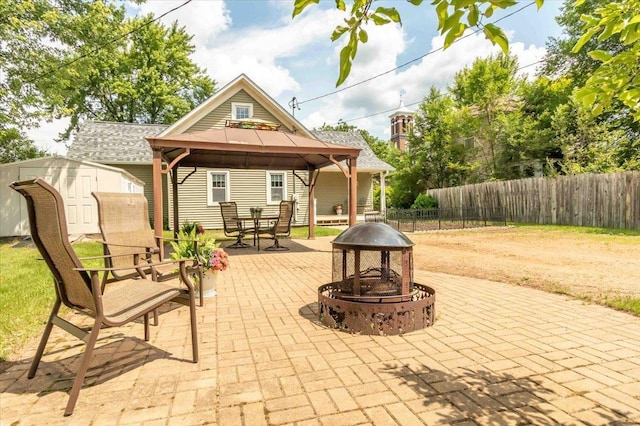 117 6th St, Nekoosa, WI 54457 - view of patio / terrace featuring an outdoor fire pit, a gazebo, and a storage shed