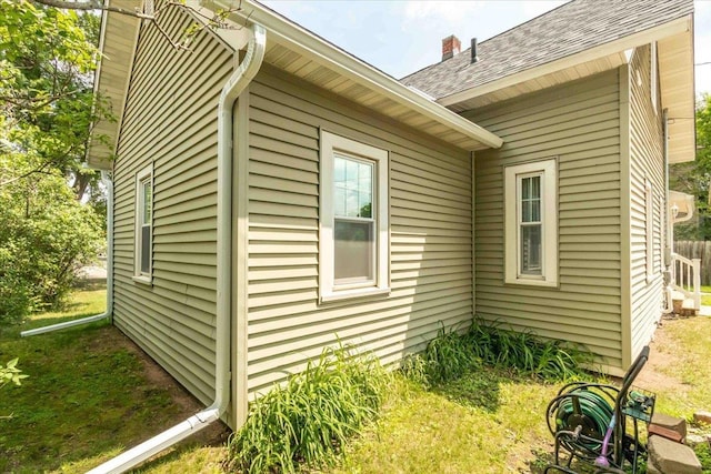 117 6th St, Nekoosa, WI 54457 - view of home's exterior with a chimney and roof with shingles