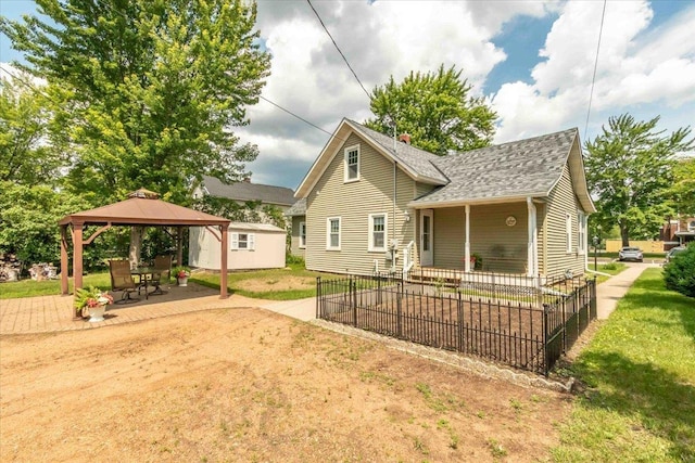 117 6th St, Nekoosa, WI 54457 - back of house featuring a gazebo, roof with shingles, a patio, and a lawn