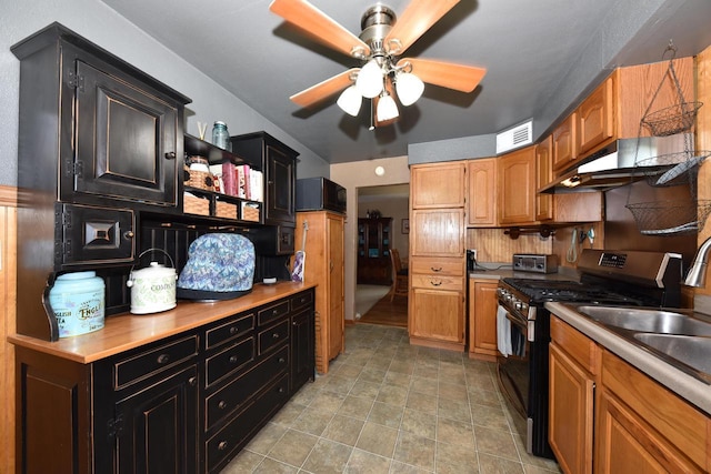 819 S 90th St, West Allis, WI 53214 - kitchen with stainless steel range with gas cooktop, under cabinet range hood, a ceiling fan, light countertops, and dark cabinets