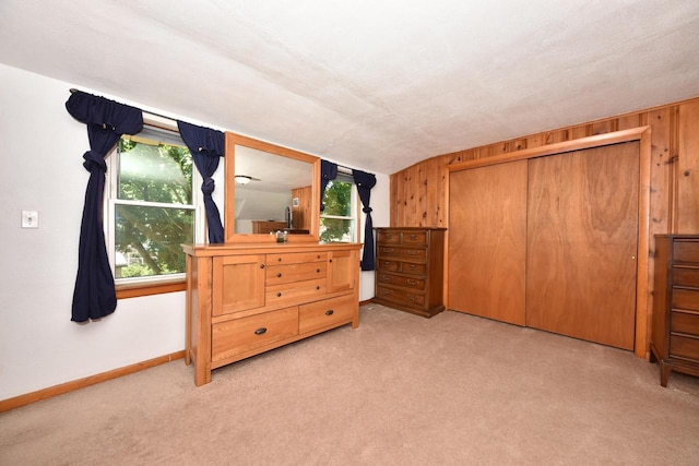 819 S 90th St, West Allis, WI 53214 - unfurnished bedroom with light colored carpet, vaulted ceiling, and a closet