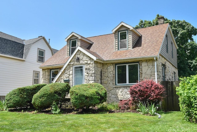 819 S 90th St, West Allis, WI 53214 - view of front of home featuring stone siding, a chimney, and roof with shingles