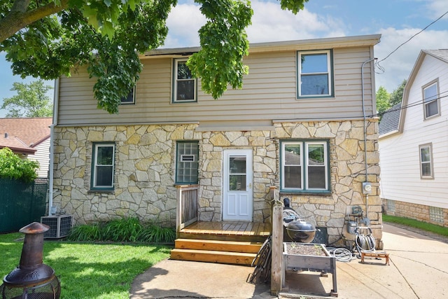 819 S 90th St, West Allis, WI 53214 - view of front of house featuring stone siding and a front lawn