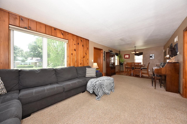 819 S 90th St, West Allis, WI 53214 - living area with light carpet, a chandelier, and wood walls