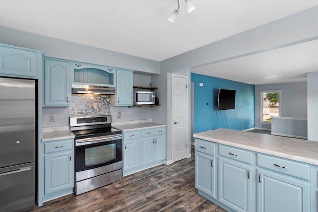 1716 Michael Dr, Waukesha, WI 53189 - kitchen featuring stainless steel appliances, under cabinet range hood, tasteful backsplash, dark wood-style flooring, and light countertops