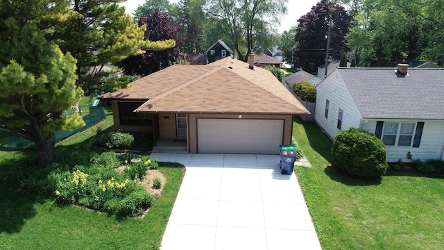 206 S High St, Port Washington, WI 53074 - view of front of home with a front lawn, concrete driveway, a garage, and a shingled roof