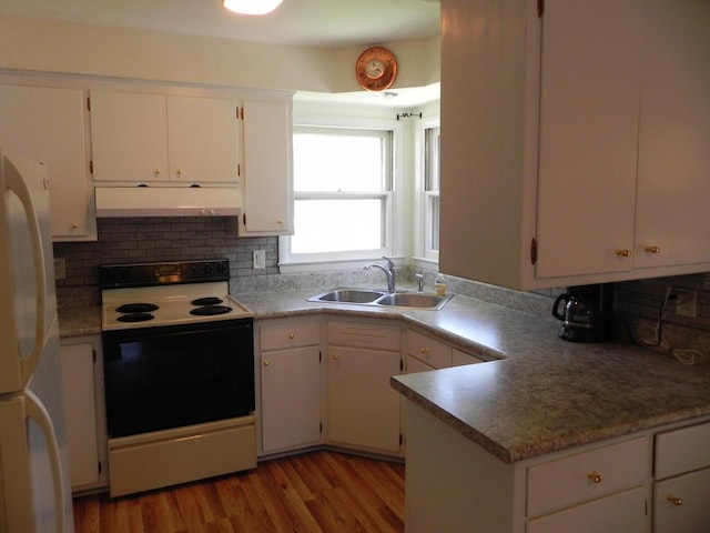 206 S High St, Port Washington, WI 53074 - kitchen with white appliances, exhaust hood, white cabinets, wood finished floors, and backsplash