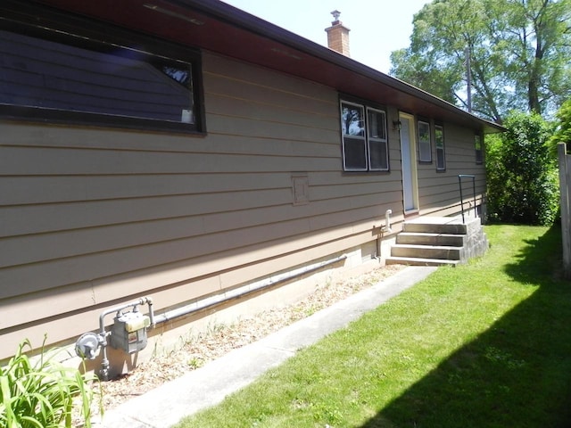 206 S High St, Port Washington, WI 53074 - view of home's exterior with a chimney and a yard