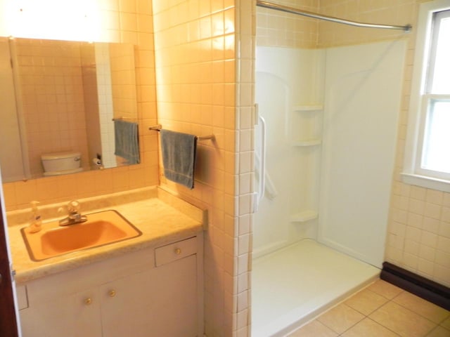 206 S High St, Port Washington, WI 53074 - bathroom with a shower stall, vanity, tile walls, and tile patterned flooring