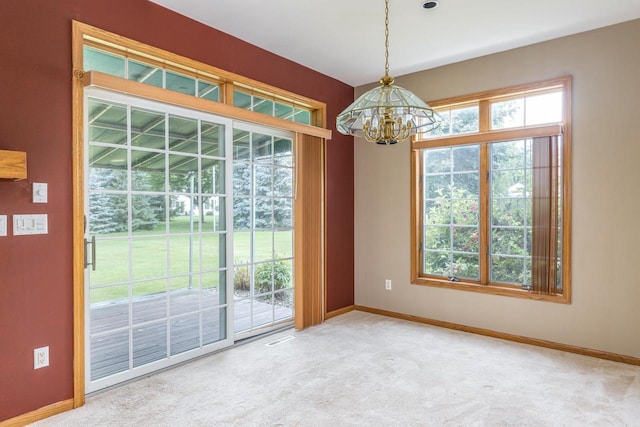 4431 Bellhaven Ln, Oshkosh, WI 54904 - unfurnished dining area with a chandelier and carpet flooring