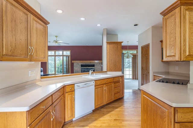4431 Bellhaven Ln, Oshkosh, WI 54904 - kitchen featuring dishwasher, ceiling fan, light wood-style flooring, light countertops, and a fireplace