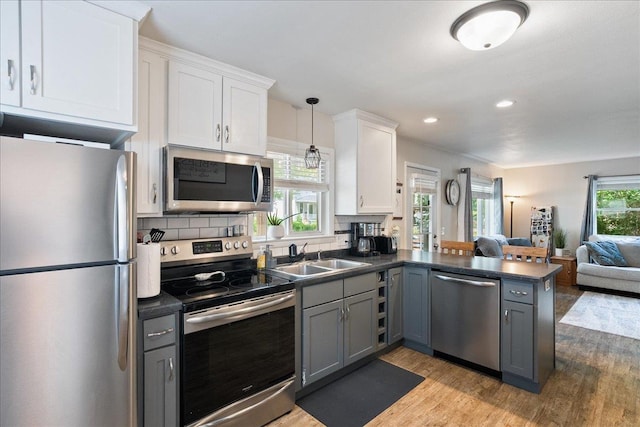 203 N Vine St, Marshfield, WI 54449 - kitchen with appliances with stainless steel finishes, dark countertops, open floor plan, gray cabinets, and recessed lighting