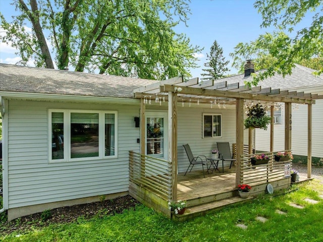 203 N Vine St, Marshfield, WI 54449 - back of property featuring a pergola, a shingled roof, a deck, and a chimney