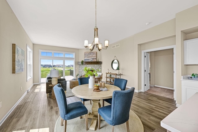 1382 Prairie Creek Cir Unit 15D, Oconomowoc, WI 53066 - dining area featuring a chandelier and wood finished floors