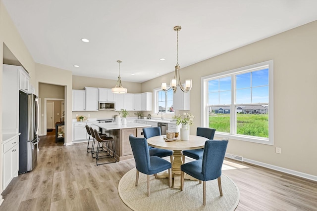 1382 Prairie Creek Cir Unit 15D, Oconomowoc, WI 53066 - dining space with light wood finished floors, recessed lighting, and a chandelier