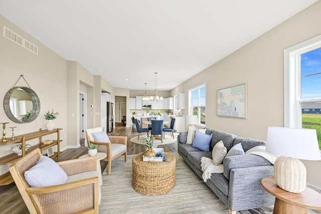 1382 Prairie Creek Cir Unit 15D, Oconomowoc, WI 53066 - living area with light wood-type flooring and a chandelier