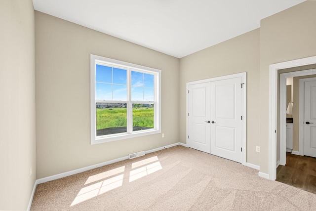 1382 Prairie Creek Cir Unit 15D, Oconomowoc, WI 53066 - unfurnished bedroom with carpet flooring and a closet