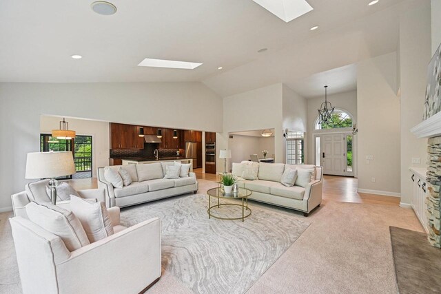 1706 Ashlawn Ln, Waunakee, WI 53597 - living room featuring a skylight, high vaulted ceiling, healthy amount of natural light, light carpet, and recessed lighting
