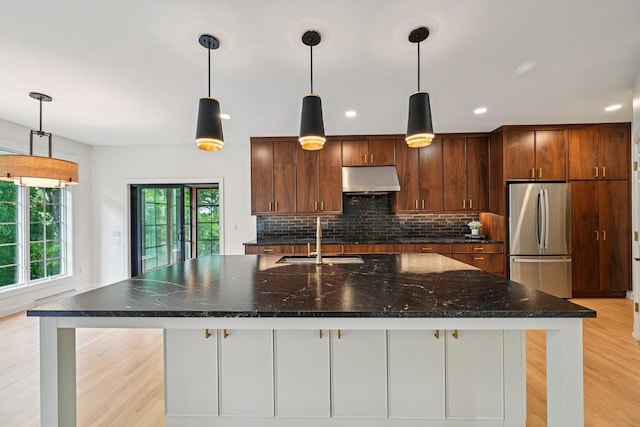 1706 Ashlawn Ln, Waunakee, WI 53597 - kitchen with freestanding refrigerator, under cabinet range hood, healthy amount of natural light, light wood-type flooring, and recessed lighting