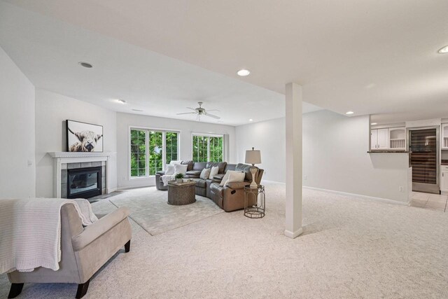 1706 Ashlawn Ln, Waunakee, WI 53597 - living room with light carpet, a tiled fireplace, recessed lighting, and a ceiling fan