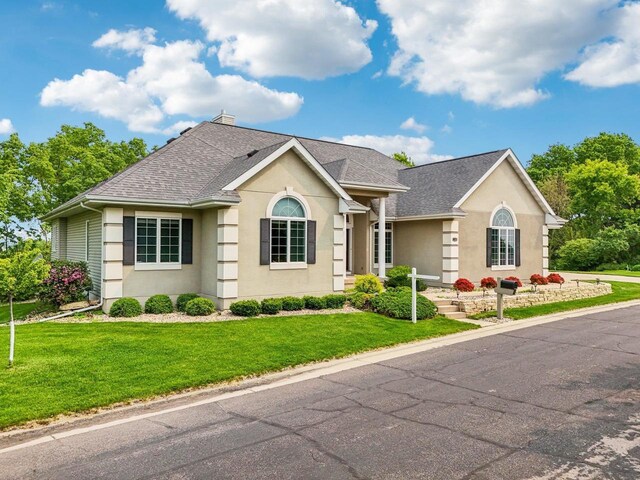1706 Ashlawn Ln, Waunakee, WI 53597 - view of front of home featuring a shingled roof, stucco siding, and a front yard