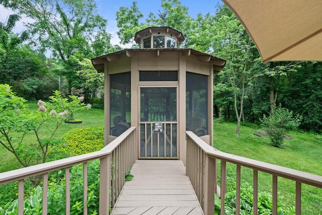 2831 N Wildwood Dr, Lake Geneva, WI 53147 - wooden deck with a sunroom and a lawn