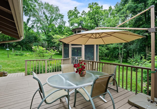 2831 N Wildwood Dr, Lake Geneva, WI 53147 - deck featuring outdoor dining area, a sunroom, a lawn, and view of scattered trees