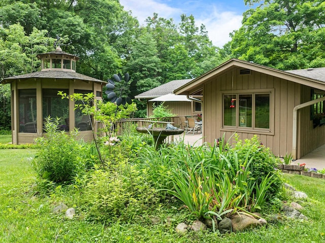 2831 N Wildwood Dr, Lake Geneva, WI 53147 - view of property exterior with a shingled roof, a sunroom, and board and batten siding