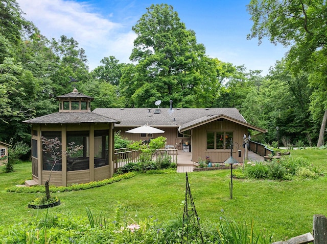 2831 N Wildwood Dr, Lake Geneva, WI 53147 - rear view of house with a lawn, a wooden deck, roof with shingles, and board and batten siding