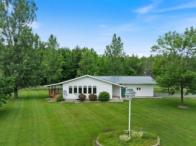 7269 County Road V, Marshfield, WI 54449 - view of front of home featuring a front yard, a metal roof, and a forest view