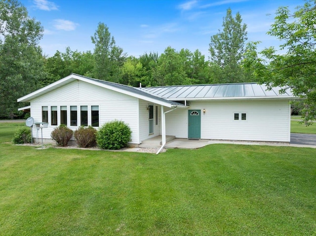 7269 County Road V, Marshfield, WI 54449 - rear view of property with a standing seam roof, a lawn, and a metal roof
