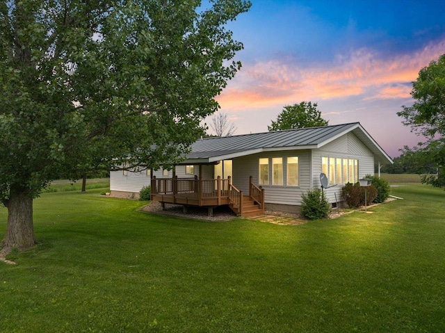 7269 County Road V, Marshfield, WI 54449 - back of property at dusk with a deck, crawl space, a yard, and a metal roof