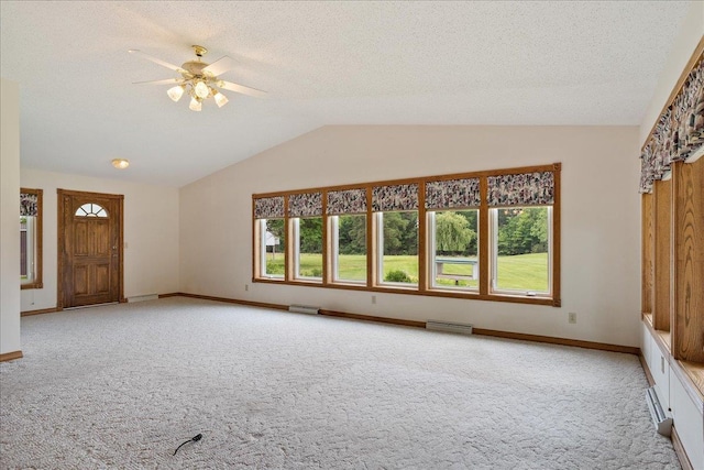 7269 County Road V, Marshfield, WI 54449 - unfurnished living room featuring carpet, healthy amount of natural light, lofted ceiling, ceiling fan, and a textured ceiling
