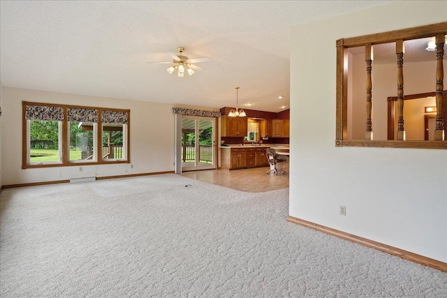 7269 County Road V, Marshfield, WI 54449 - unfurnished living room with light colored carpet, a ceiling fan, and a chandelier