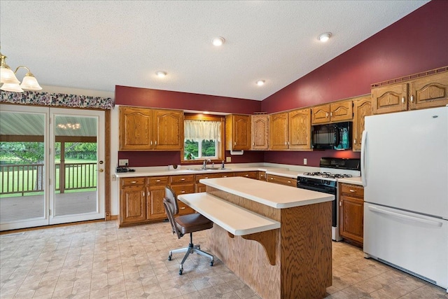 7269 County Road V, Marshfield, WI 54449 - kitchen with freestanding refrigerator, gas range oven, black microwave, lofted ceiling, and light countertops