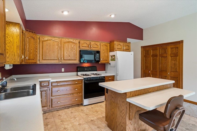 7269 County Road V, Marshfield, WI 54449 - kitchen with black microwave, gas stove, freestanding refrigerator, lofted ceiling, and light countertops