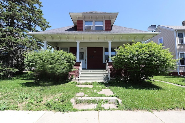 1416 Michigan Ave Unit 1416A, Sheboygan, WI 53081 - bungalow-style house featuring covered porch, a shingled roof, and a front lawn