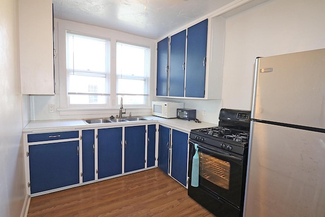 1416 Michigan Ave Unit 1416A, Sheboygan, WI 53081 - kitchen featuring freestanding refrigerator, blue cabinetry, and gas stove