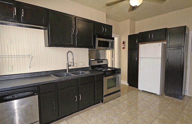 1416 Michigan Ave Unit 1416A, Sheboygan, WI 53081 - kitchen with stainless steel appliances, dark cabinets, a ceiling fan, dark countertops, and light tile patterned flooring