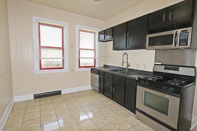 1416 Michigan Ave Unit 1416A, Sheboygan, WI 53081 - kitchen with stainless steel appliances, dark cabinets, dark countertops, and light tile patterned floors