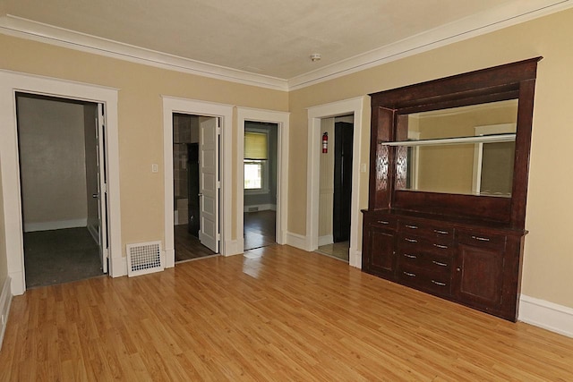 1416 Michigan Ave Unit 1416A, Sheboygan, WI 53081 - unfurnished bedroom with ornamental molding, light wood-style floors, and ensuite bathroom