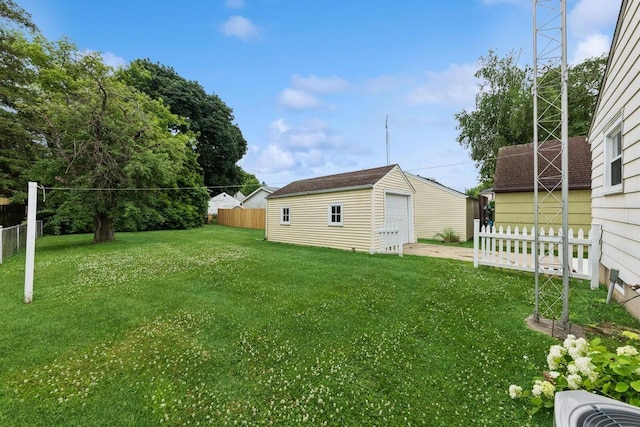 6109 38th Ave, Kenosha, WI 53142 - view of yard with a detached garage, an outbuilding, and driveway