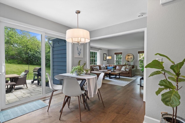 9848 N Lamplighter Ln, Mequon, WI 53092 - dining room featuring dark wood-style flooring, a chandelier, and a textured wall
