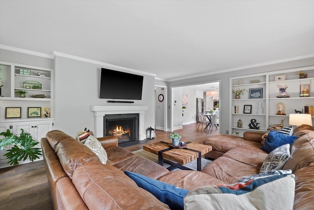 9848 N Lamplighter Ln, Mequon, WI 53092 - living room with crown molding, wood finished floors, built in features, and a fireplace with flush hearth