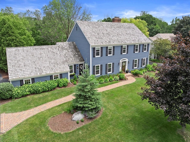 9848 N Lamplighter Ln, Mequon, WI 53092 - colonial-style house featuring a chimney and a front lawn